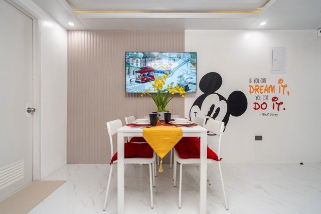 Mickey in Lipa dining area with Disney TV display and Dream it Do it quote