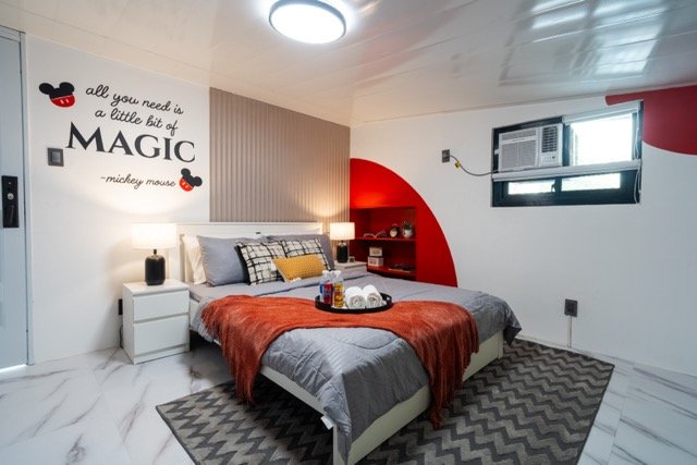 Mickey in Lipa master bedroom with queen bed and Disney inspired wall art